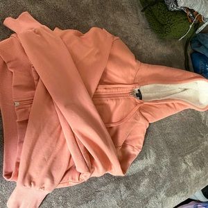 Pink fluffy cropped jacket. Super soft in the inside. Good material.